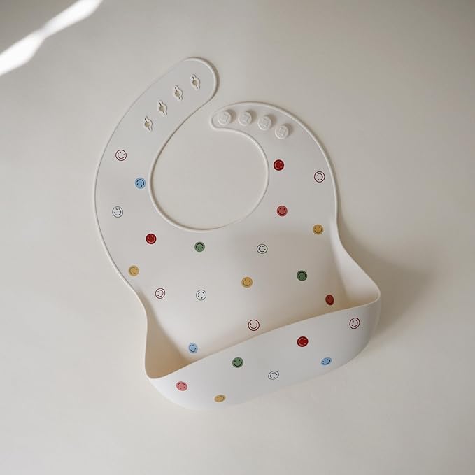 mushie Silicone Baby Bib | Adjustable Fit Waterproof Bibs (Smiley Face)